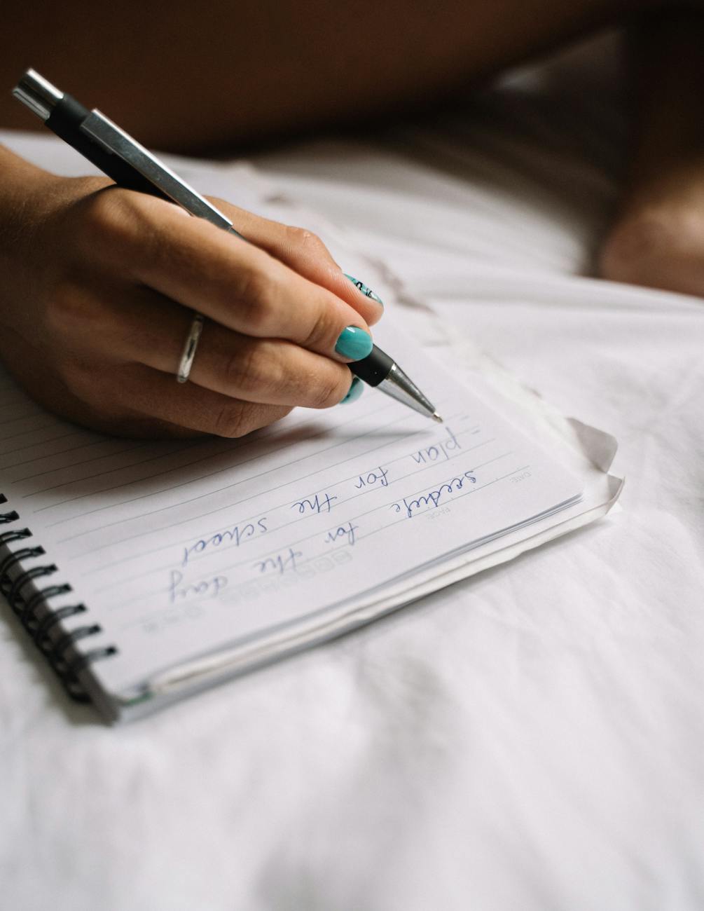 close up photo of a person writing on a notebook