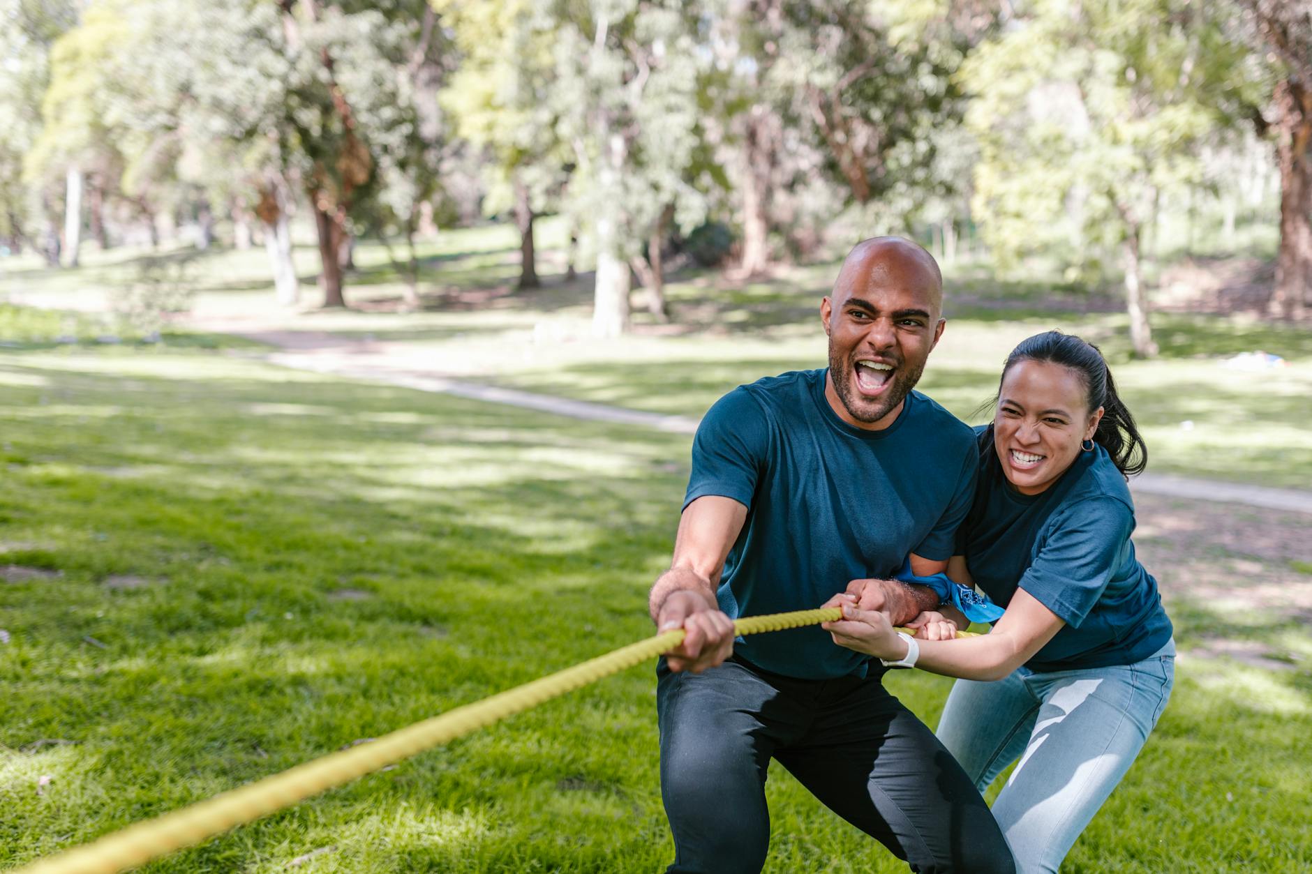 man and woman pulling a rope