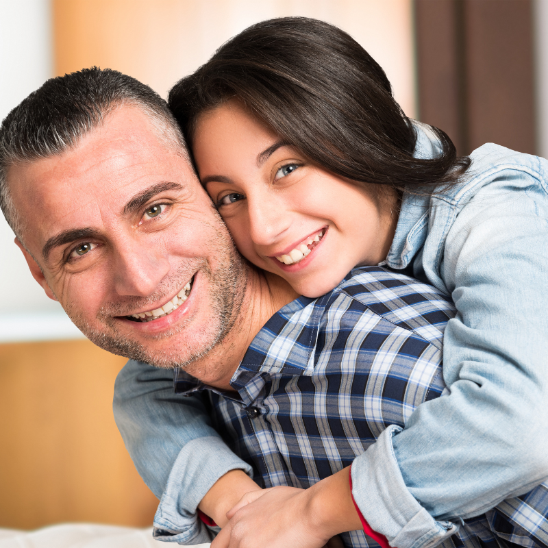 dad and daughter looking happy and relaxed after using printable worksheets