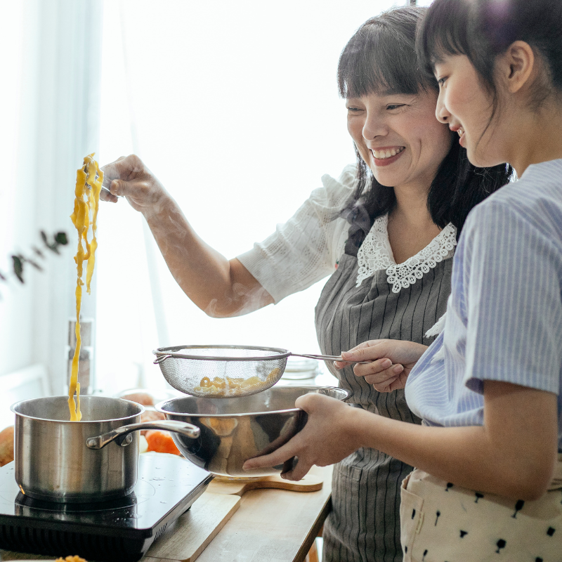 mother and child cooking together after mom learned to parent her child through recovery